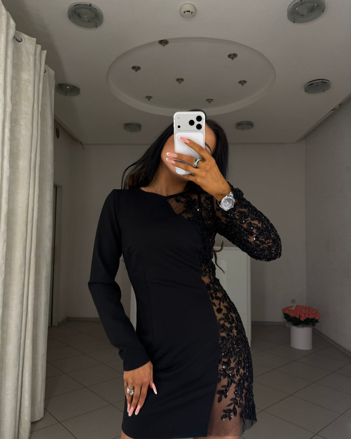 Black long sleeve mini dress with asymmetric cut and embroidered insert, front view