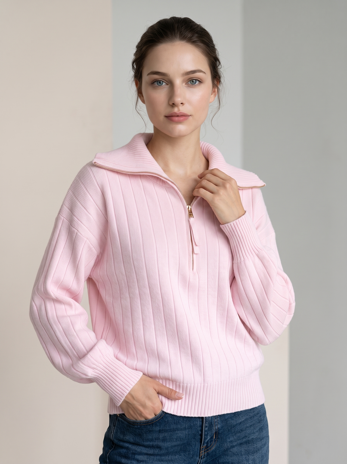 Woman wearing pink ribbed knit half-zip sweatshirt with jeans, front view