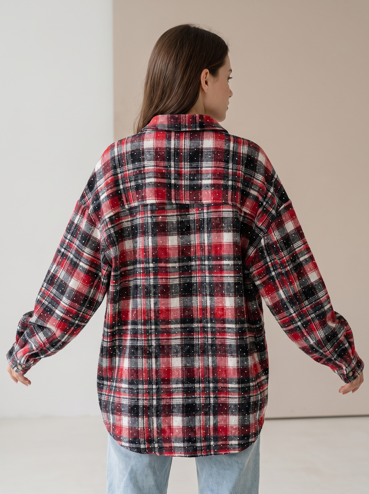 Red, black and white plaid flannel shacket cuff with cozy cream sherpa lining, close-up