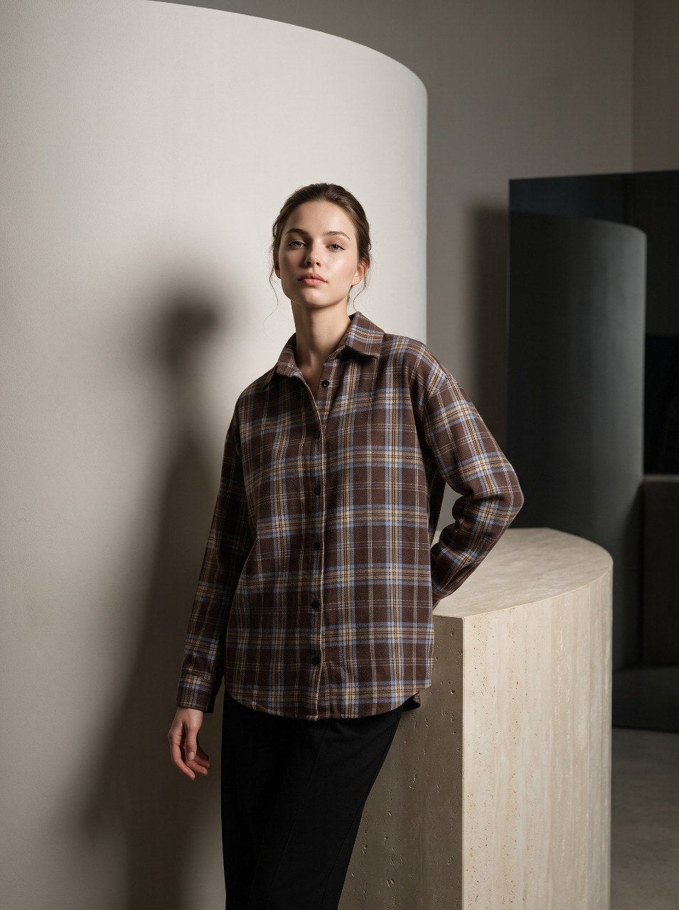 Brown plaid flannel overshirt with relaxed oversized fit, styled with black trousers, front view