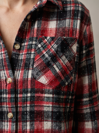 Red, black and white plaid rhinestone flannel shacket worn open over a white top and jeans, front view