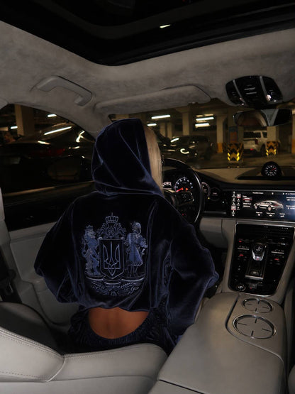 Close-up back view of velour hoodie texture with embroidered Ukrainian coat of arms