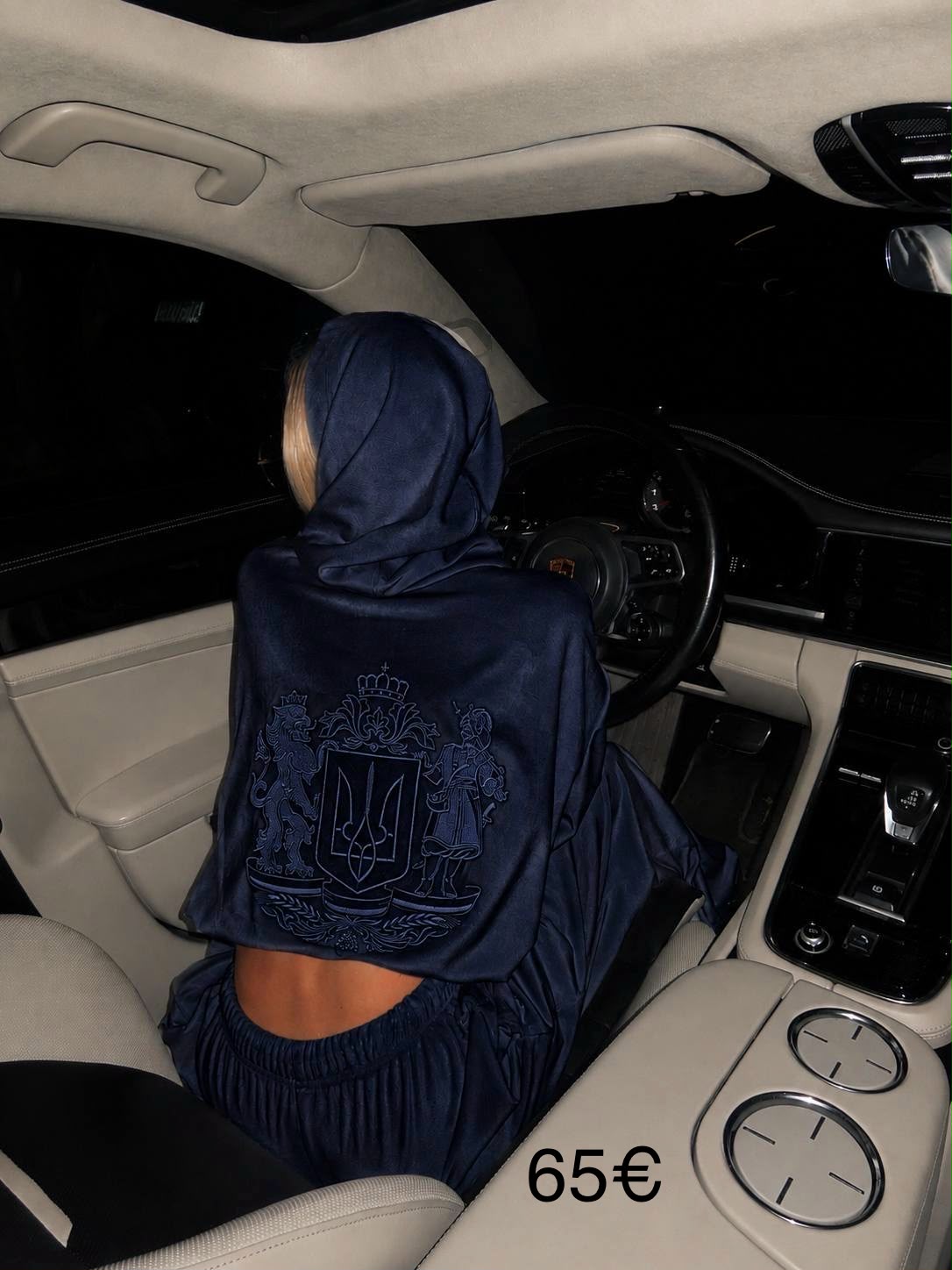 Back view of navy velour cropped hoodie showing full Ukrainian coat of arms embroidery detail