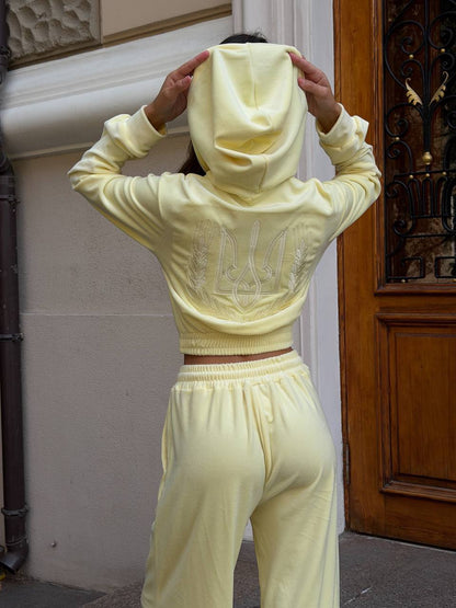 Light yellow velour tracksuit with embroidered trident and wheat wreath, oversized loungewear set, front view