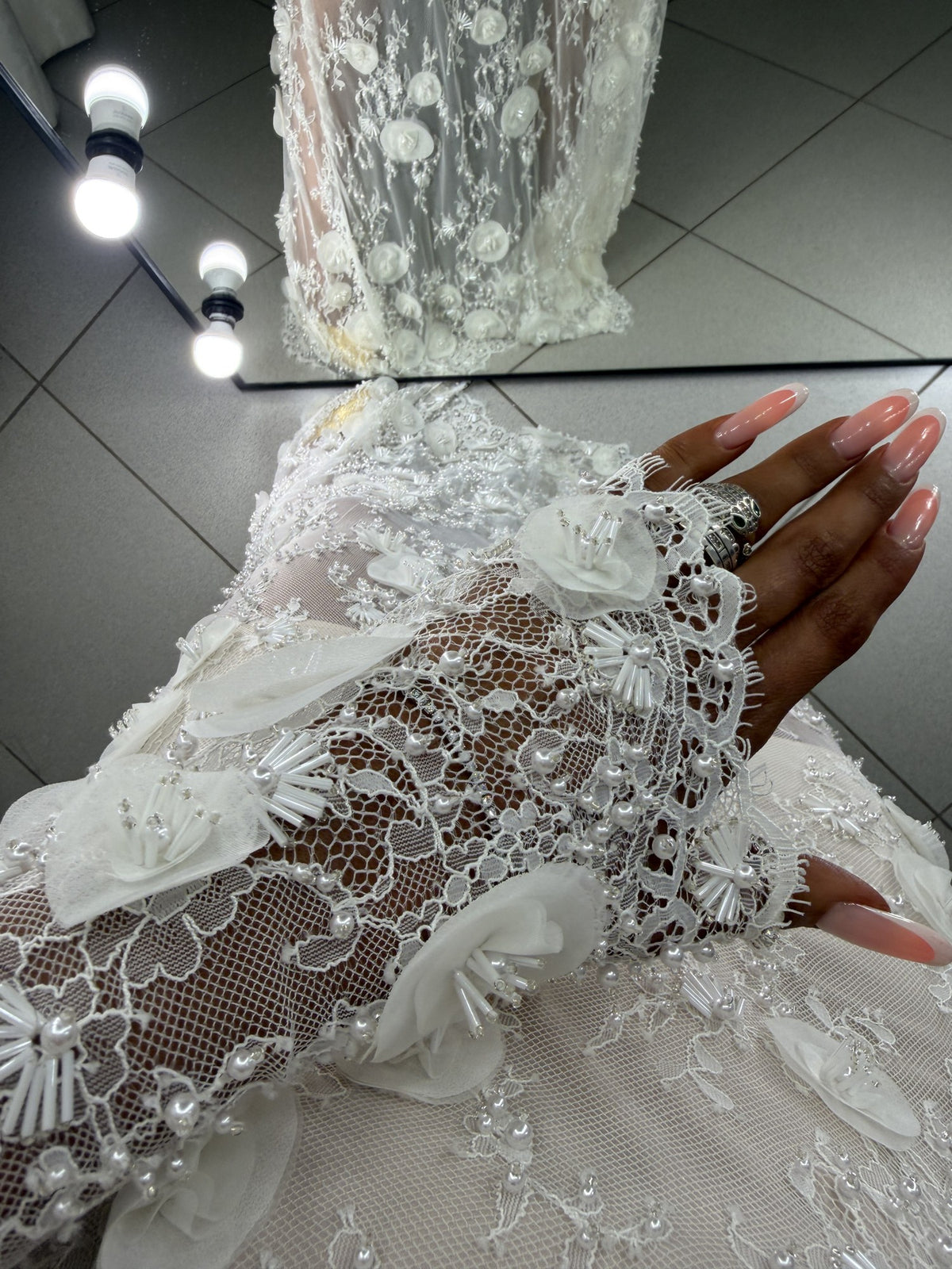 Close-up of Agata lace sleeve cuff decorated with 3D flowers and pearls