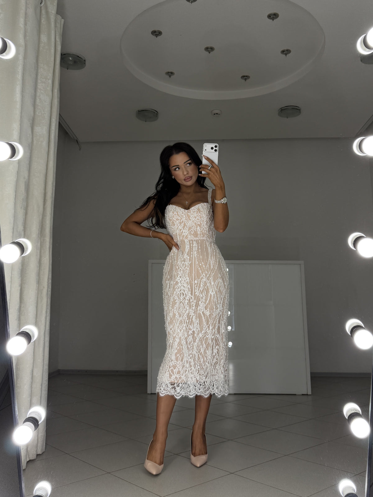 Detail of pearl and sequin embroidered lace on a white midi dress with nude lining