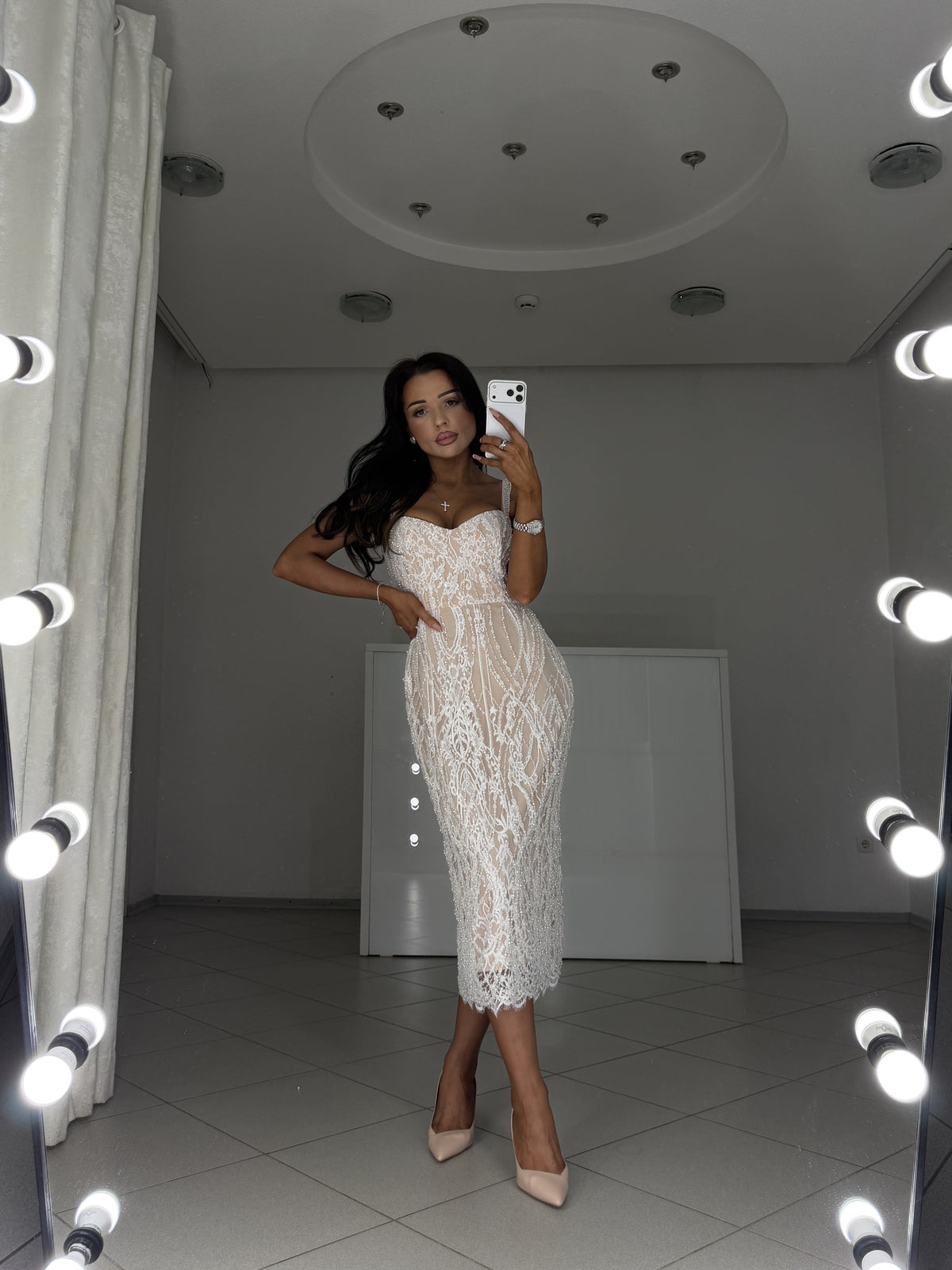 Elegant evening midi dress with sweetheart bodice and scalloped lace hem - full-length mirror view, crossed legs