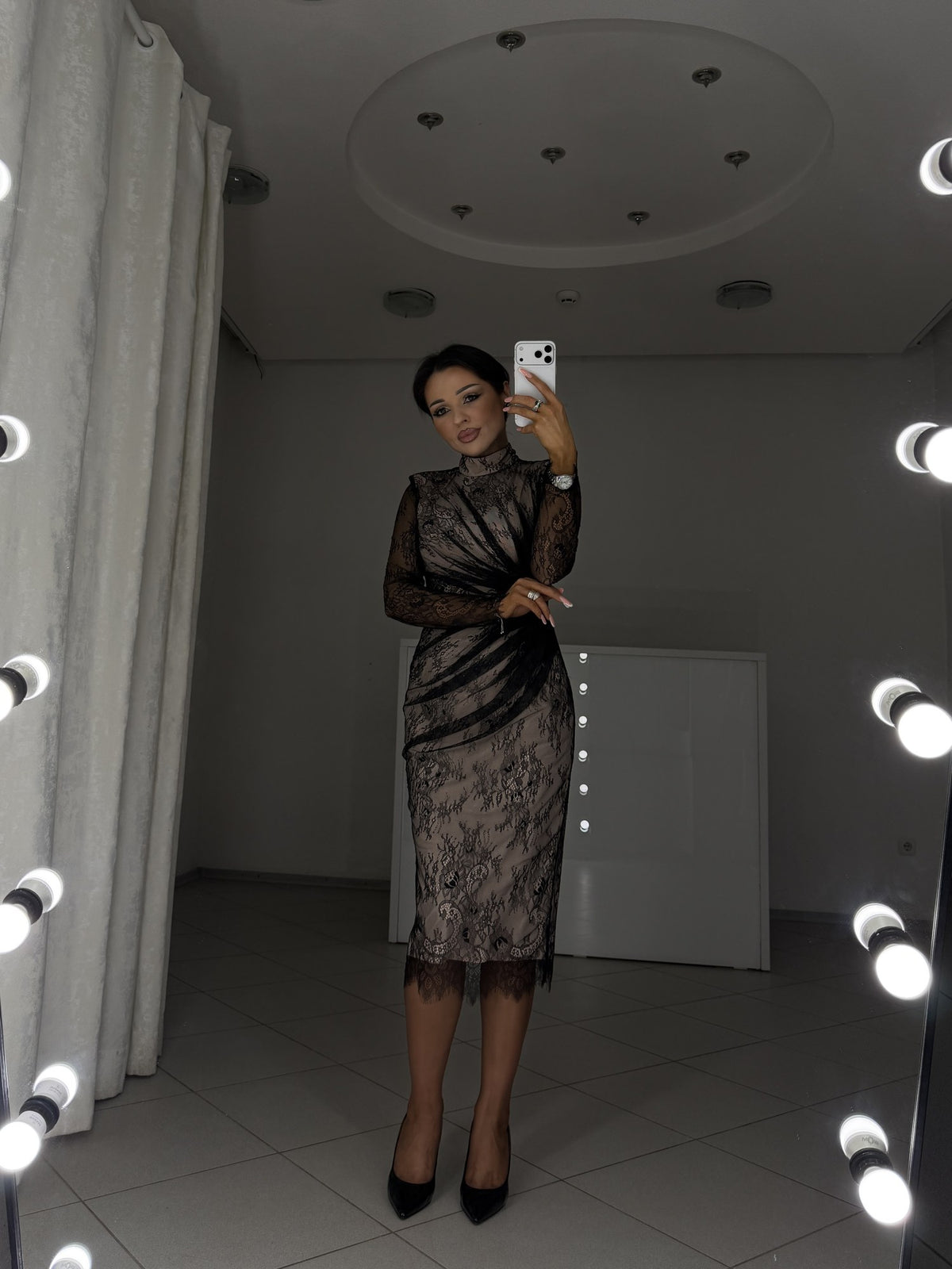 Black lace midi dress with architectural draping and long sleeves - front view