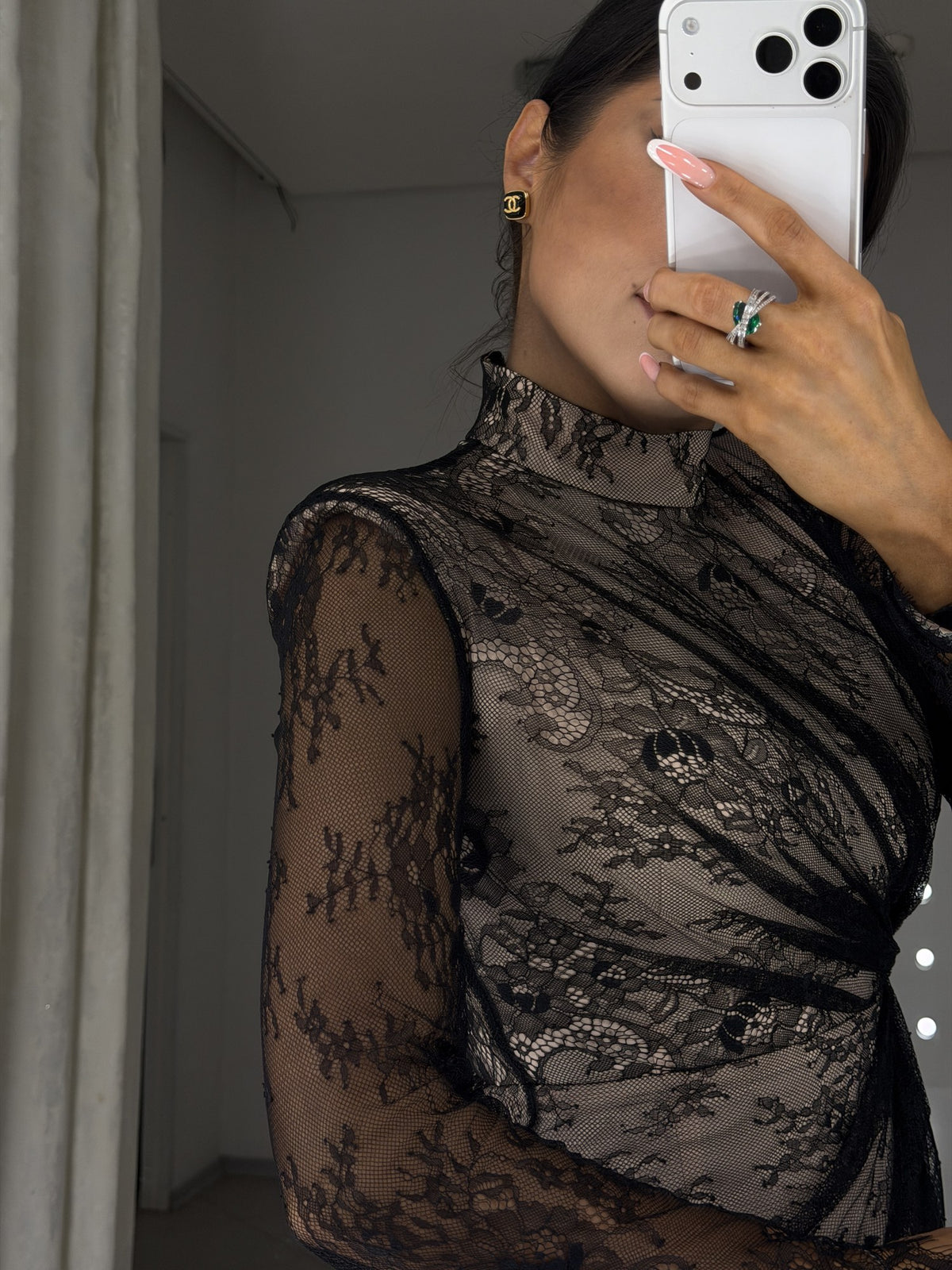 Carla dress detail - black lace sleeve, high neckline and draping