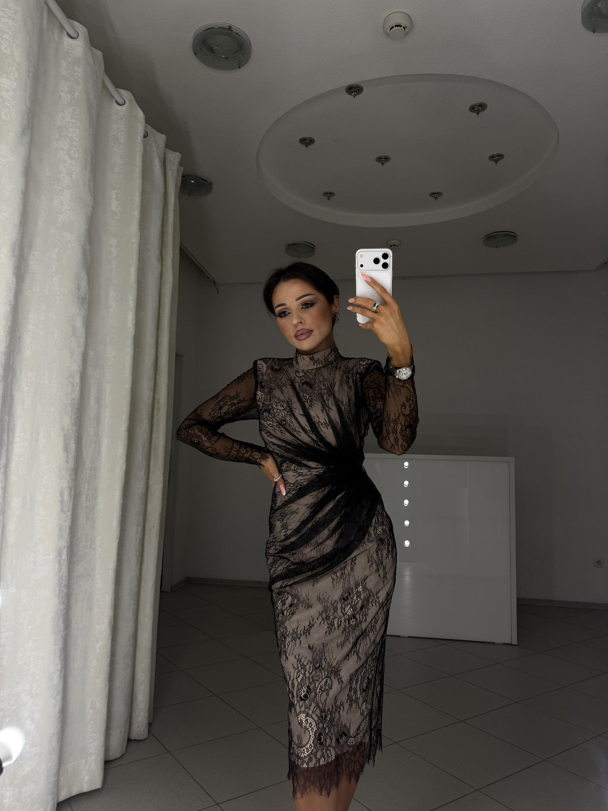 Black lace dress with shoulder pads and long sleeves - waist-up view