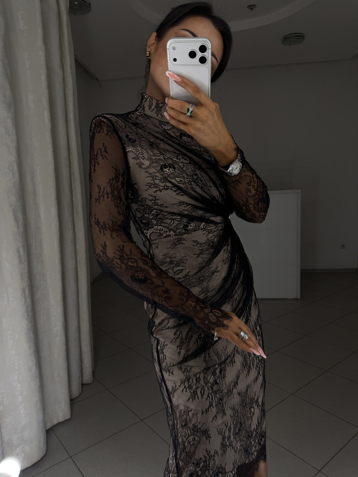 Black lace dress with beige lining and fitted silhouette - close-up