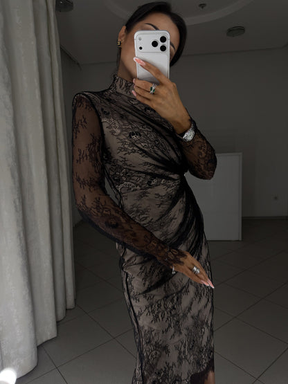 Black lace dress with beige lining and fitted silhouette - close-up