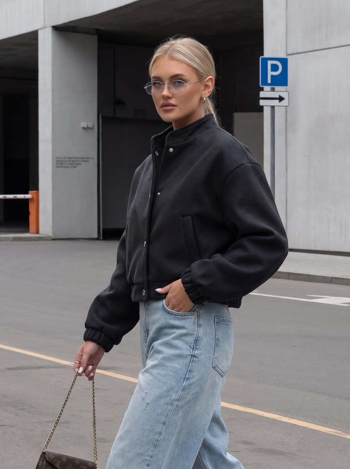 Black wool-blend cropped bomber jacket styled with wide-leg jeans - side view
