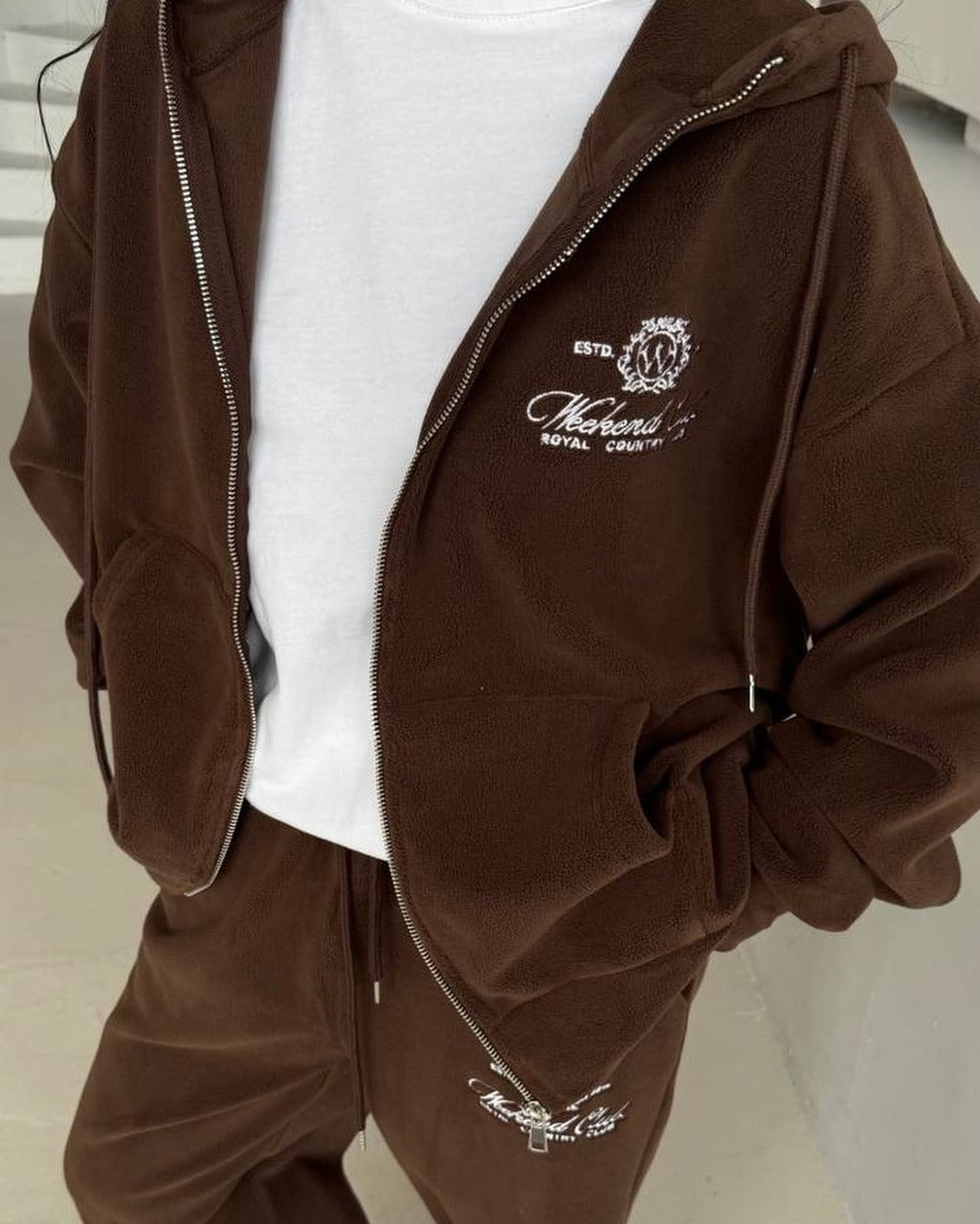 Chocolate brown fleece zip hoodie and wide trousers with embroidery, close-up