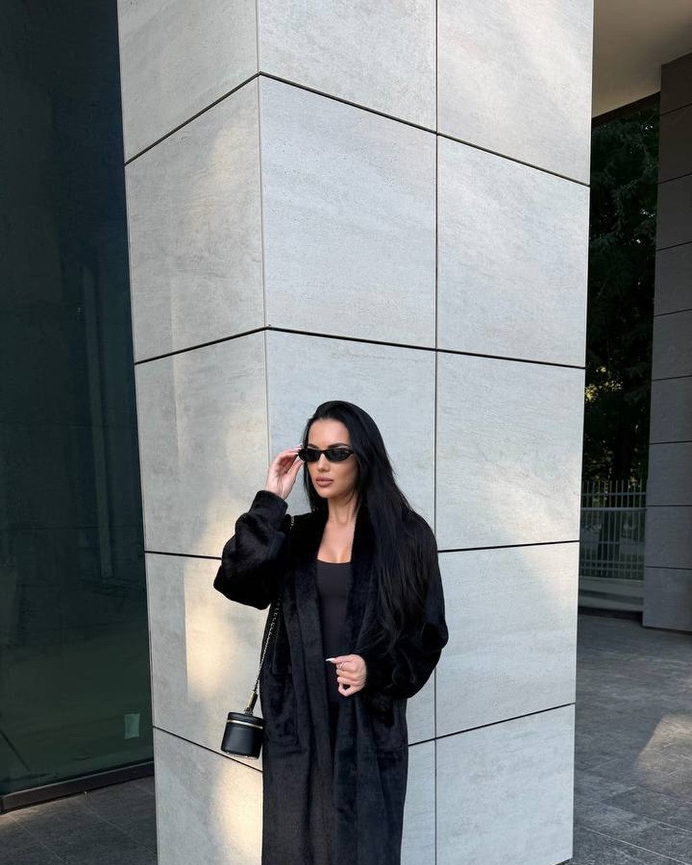 Black faux fur coat with mink-style plush texture, oversized cardigan-style silhouette, worn open, front view