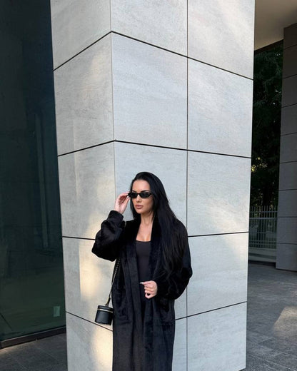 Black faux fur coat with mink-style plush texture, oversized cardigan-style silhouette, worn open, front view