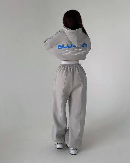 Gray fleece-lined tracksuit - back view with a blue and white back print and wide-leg trousers with pintuck seams