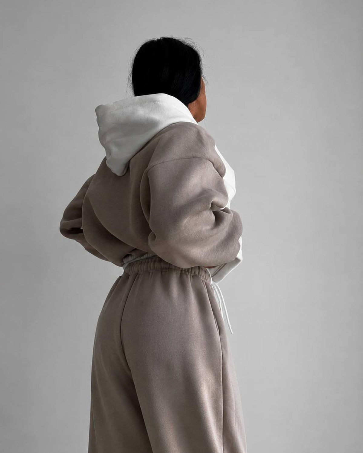 Beige hoodie back with a milk-white hood and beige wide joggers - back view