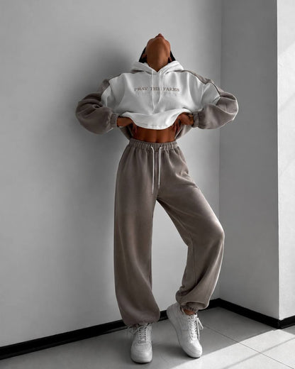 Milk-white hoodie with beige sleeves and beige wide joggers - full-length front view with white sneakers