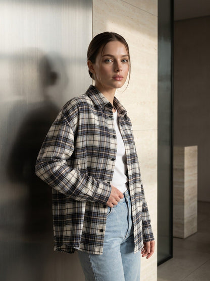 Beige plaid flannel overshirt worn open over a white top with jeans – oversized relaxed-fit shirt for casual everyday layering, front view