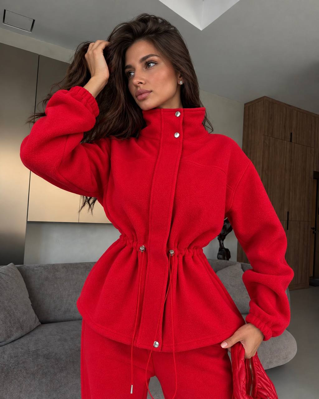 Red fleece jacket "FreeStyle" with snap placket and drawstring waist - close-up of the fabric and cord stoppers