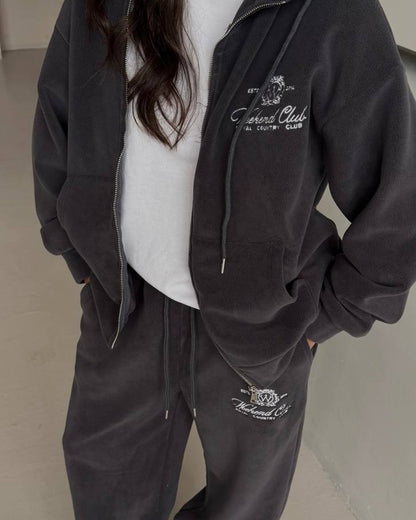 Graphite fleece zip hoodie and wide trousers with embroidery, close-up