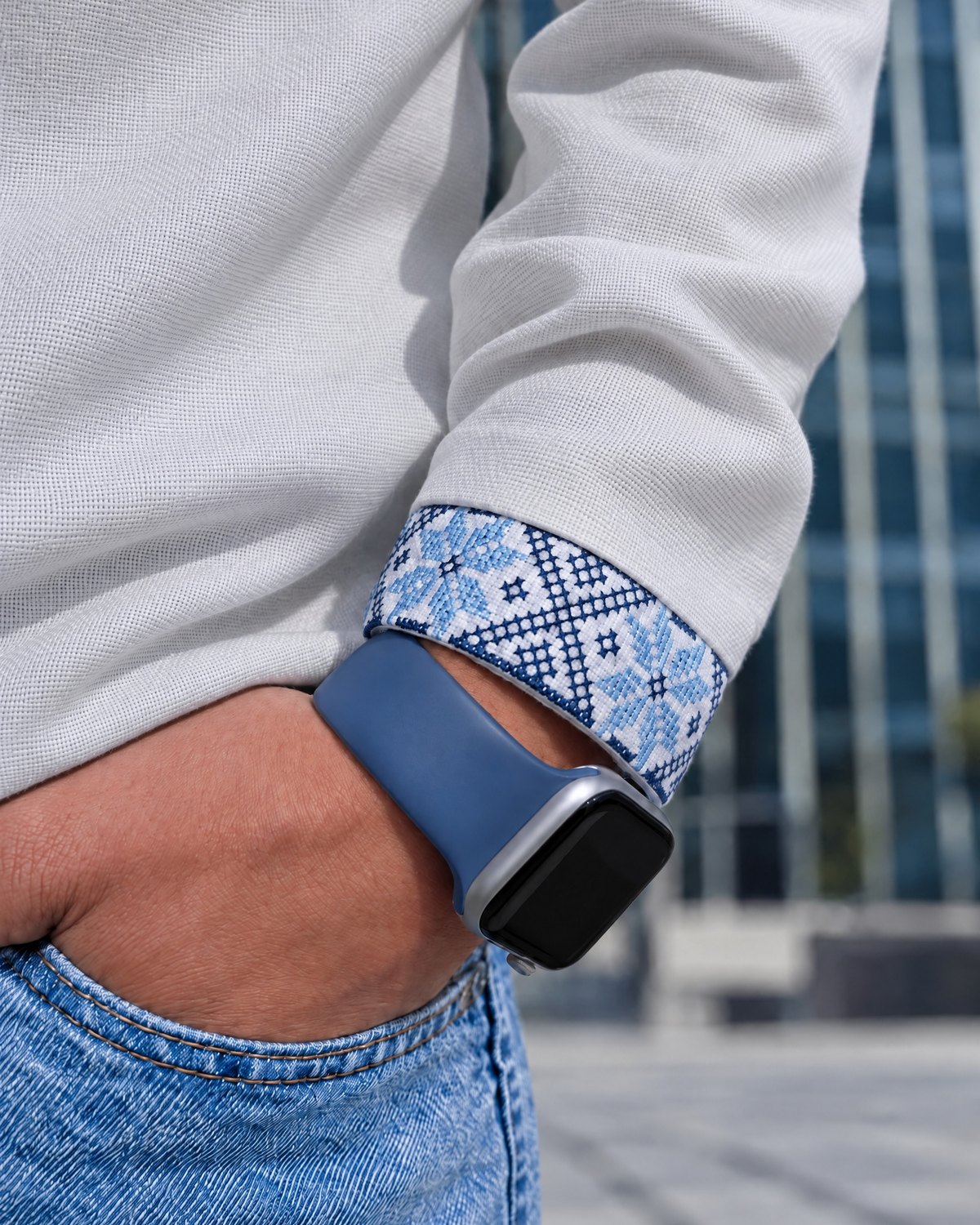 Close-up of the blue embroidered cuff of a long-sleeve white vyshyvanka