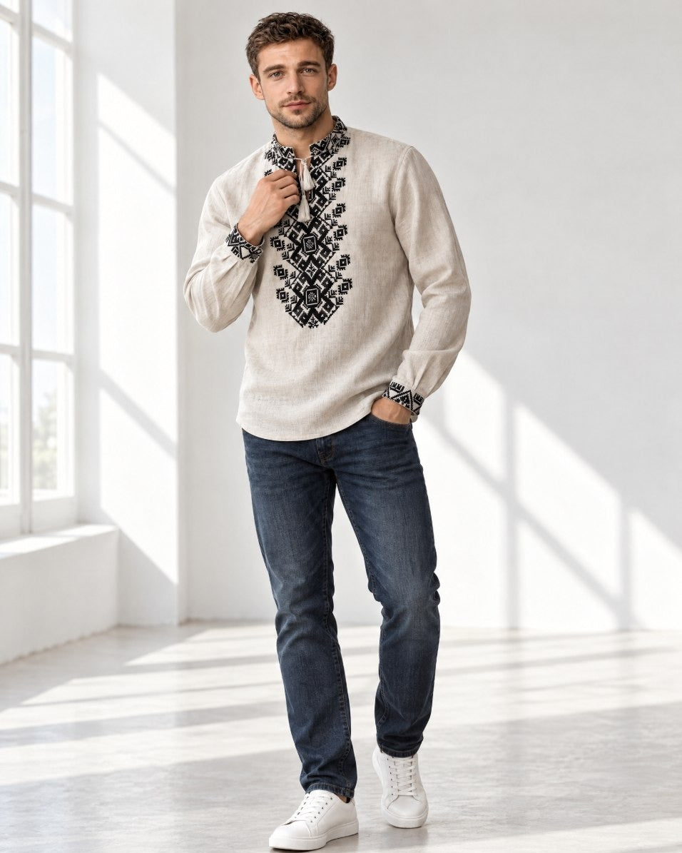 Man in a natural linen vyshyvanka with black embroidery and dark jeans, full-length view