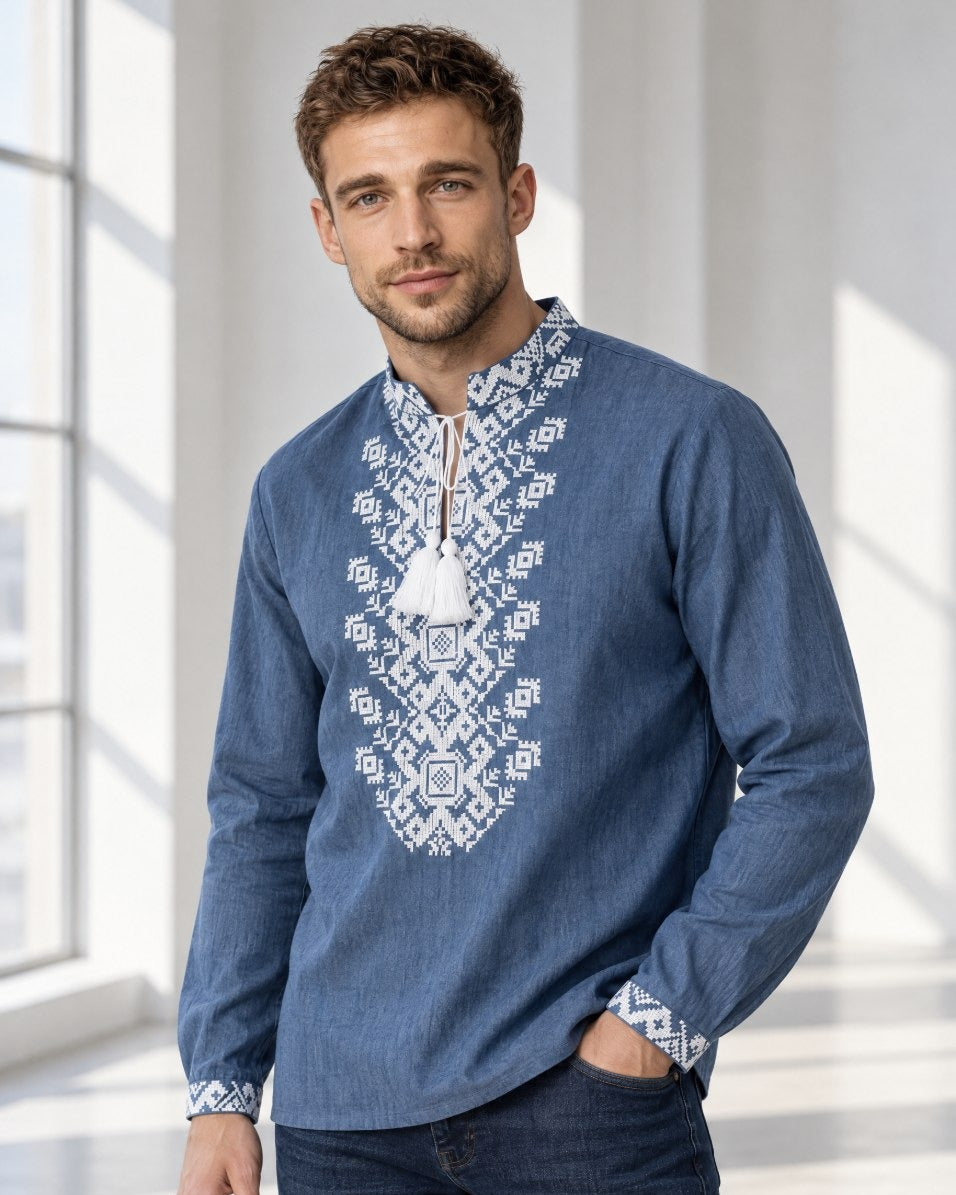 Men's blue linen vyshyvanka with white cross-stitch embroidery - front view, hand in pocket