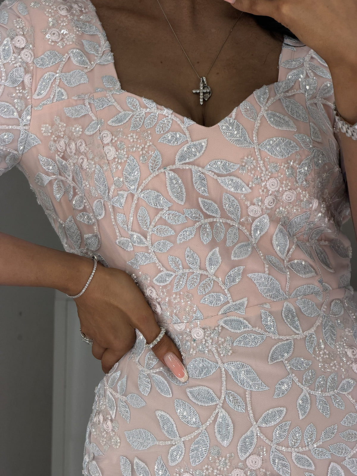Detail of sky-blue and powder-pink lace with beads and satin roses on Linda dress neckline