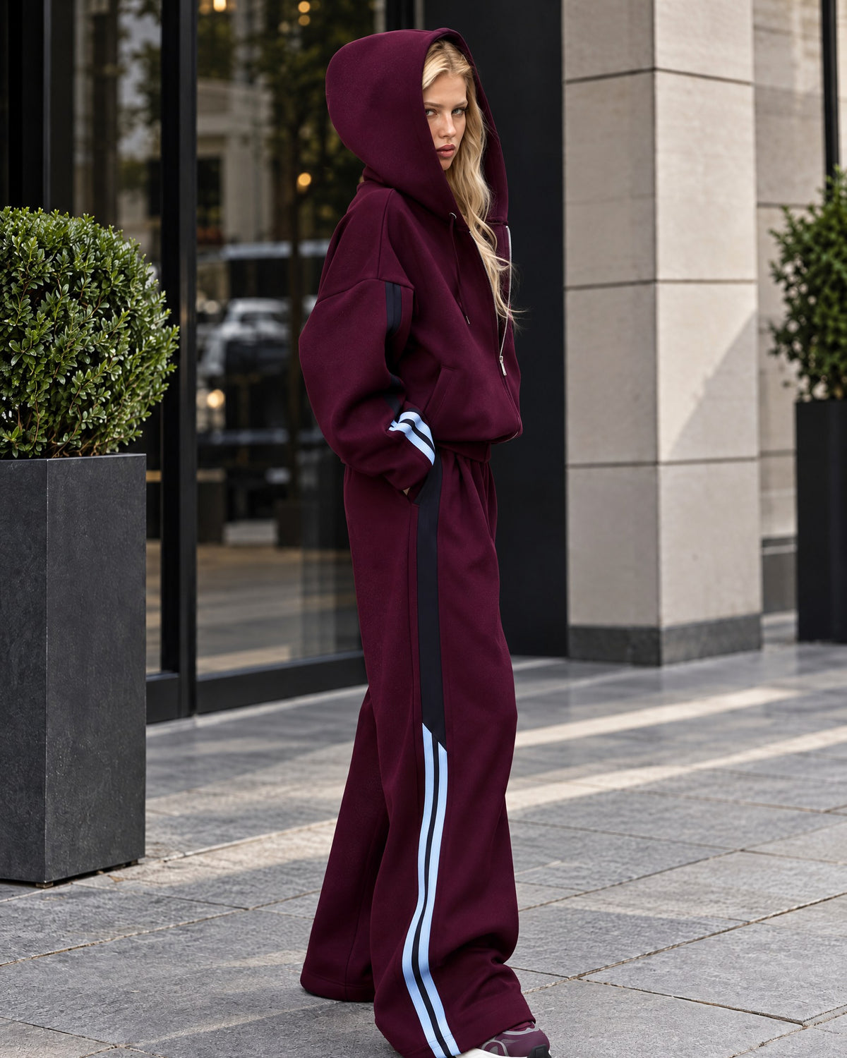 Marsala women's tracksuit with black and light-blue stripes - side view with the hood up