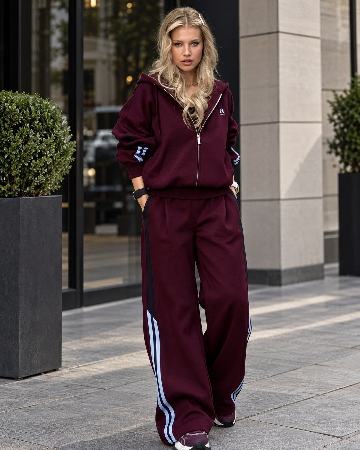 Marsala fleece-lined tracksuit with light-blue and black side stripes - front view, hands in pockets
