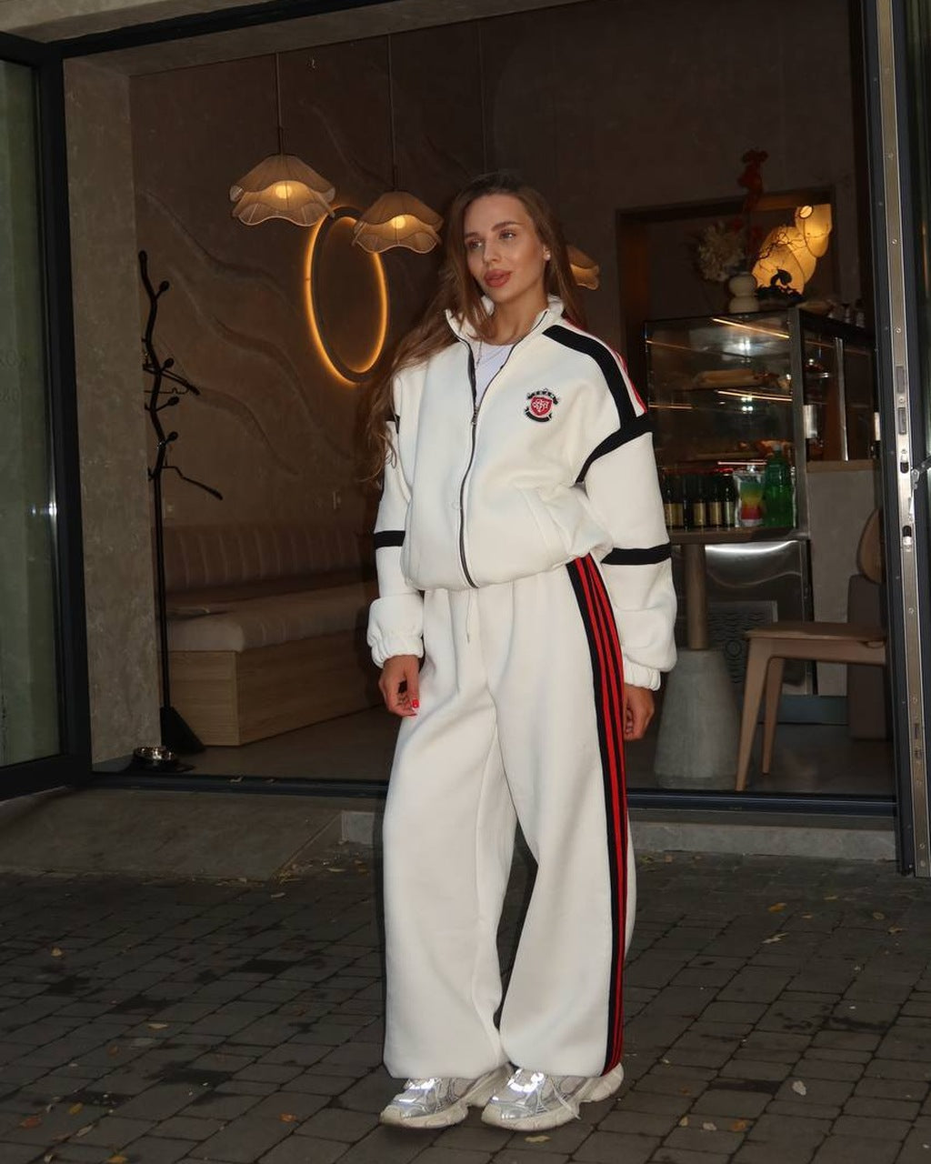 Milk women's tracksuit with black panels and red stripes, zip jacket and wide-leg trousers, front view