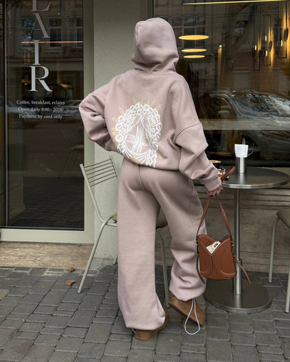 Beige women's tracksuit with hoodie and wide trousers, back view with print