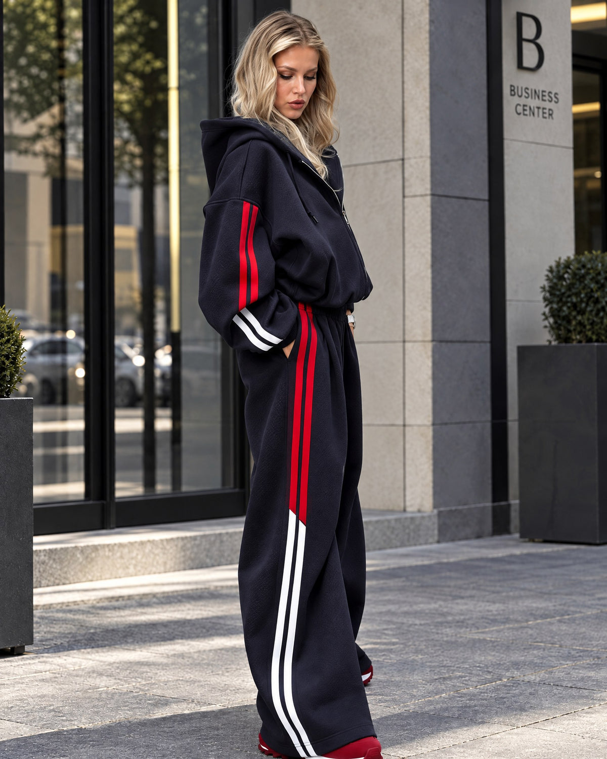 Dark blue wide-leg tracksuit with red and white side stripes - side view
