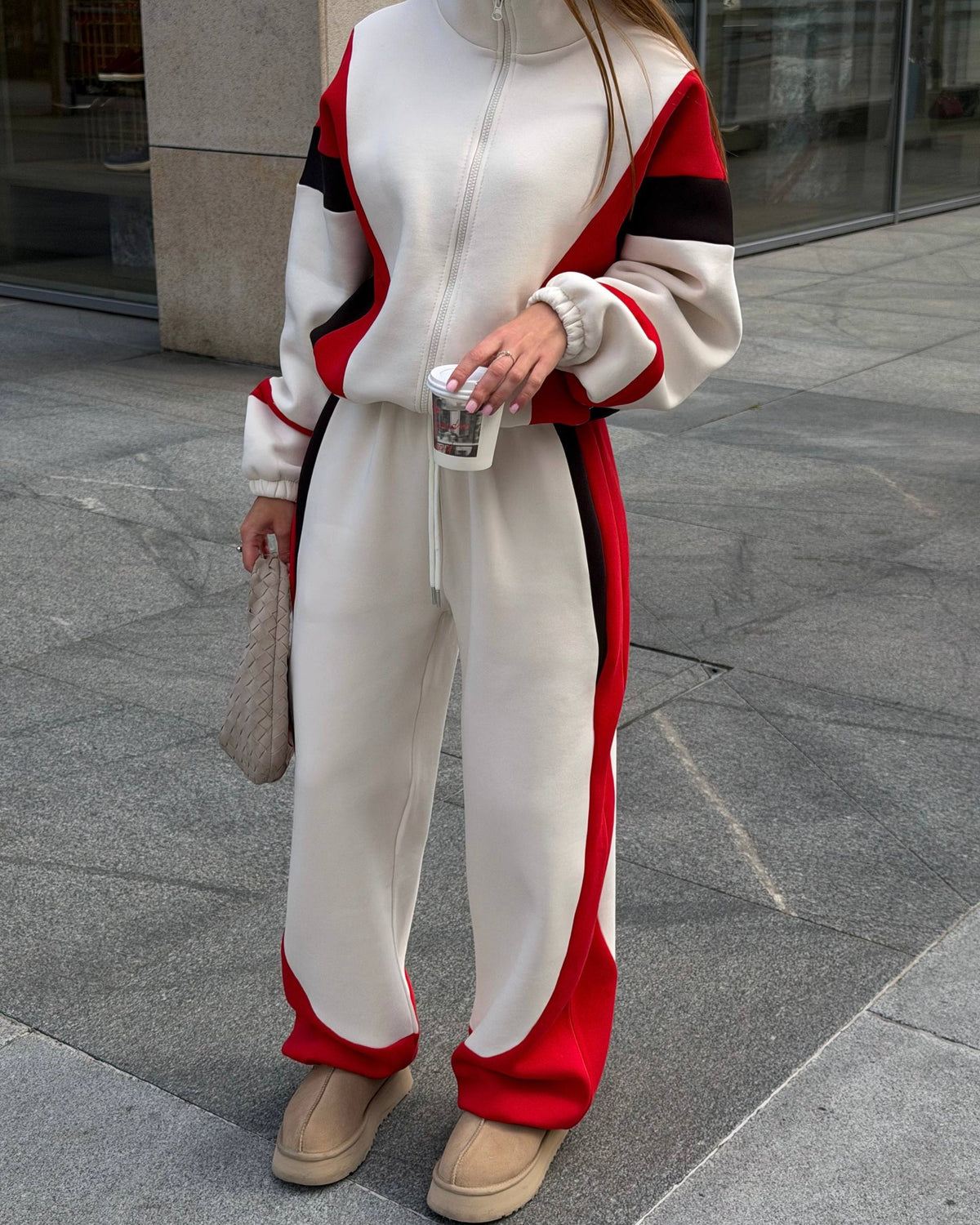 Cream colour-block tracksuit with red and black panels - front view of the zip jacket and wide-leg trousers