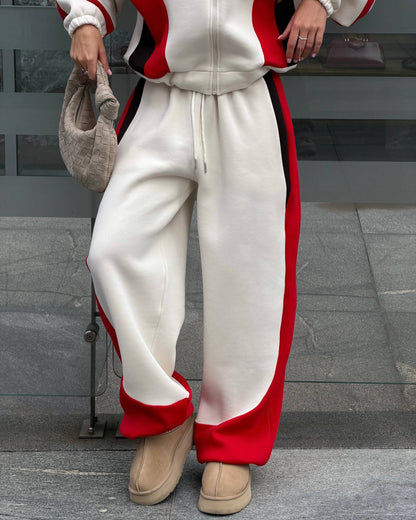 Cream wide-leg trousers with drawstring waist and red side panel - close-up with beige platform boots