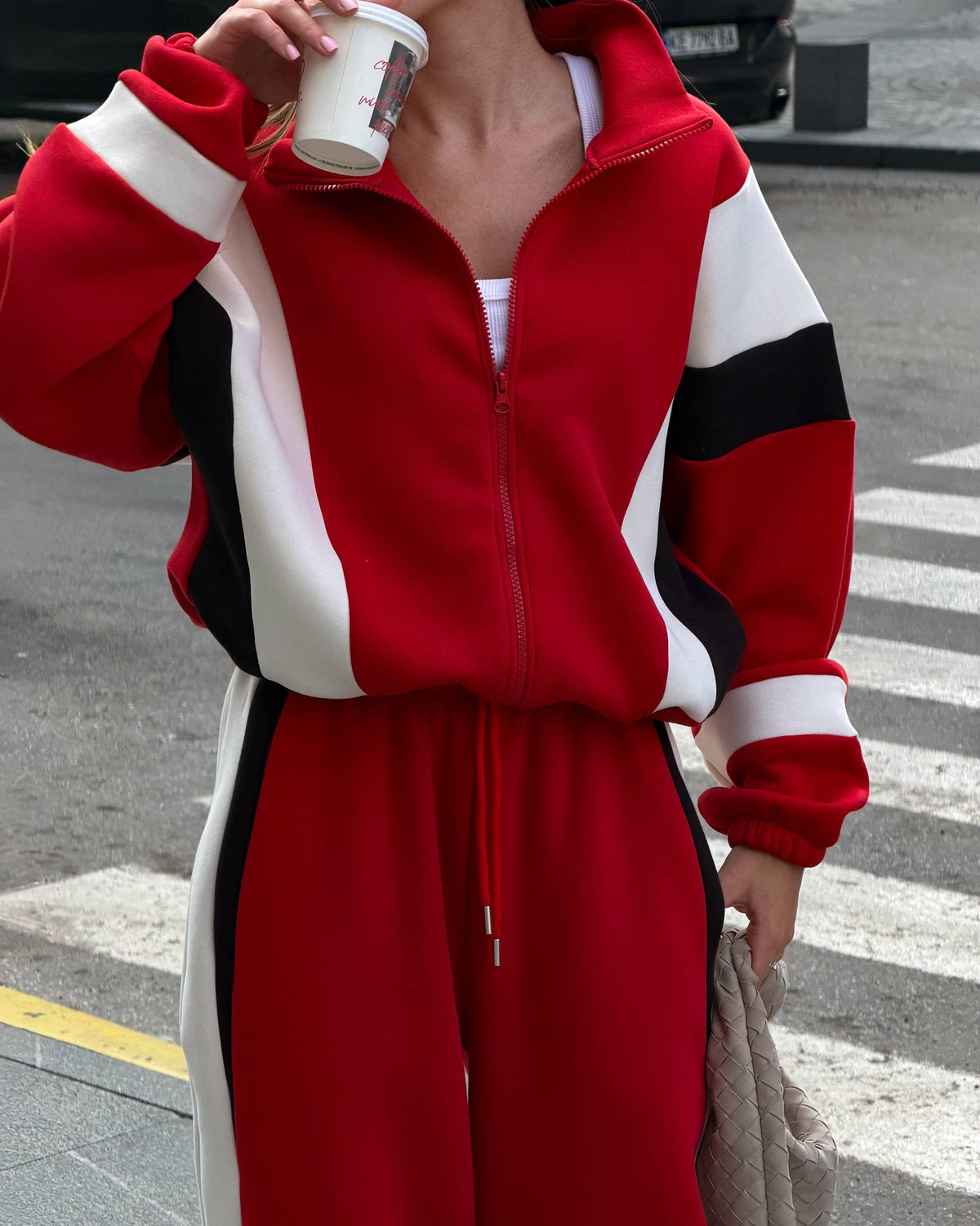 Red zip jacket with cream and black colour-block panels and elastic cuffs - close-up