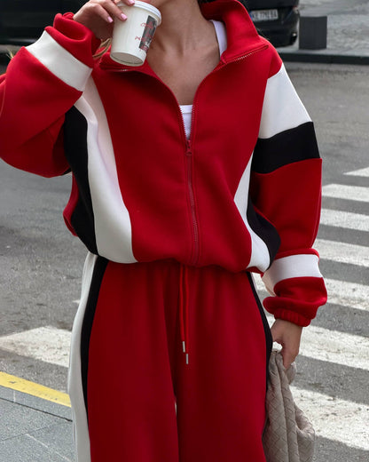 Red zip jacket with cream and black colour-block panels and elastic cuffs - close-up