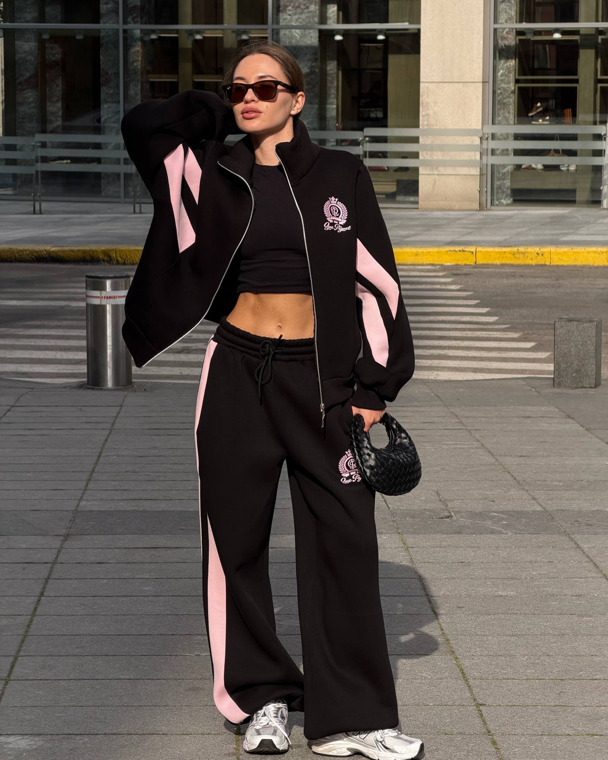 Black tracksuit with pink colour-block panels - full-length front view with the zip jacket worn open and wide-leg trousers