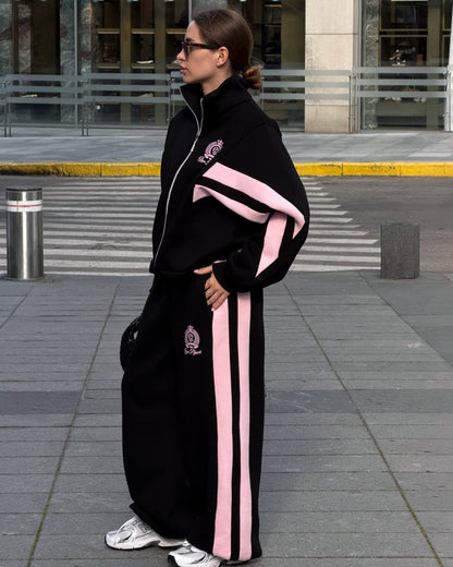 Black colour-block tracksuit with pink stripes - side view of the jacket and wide-leg trousers