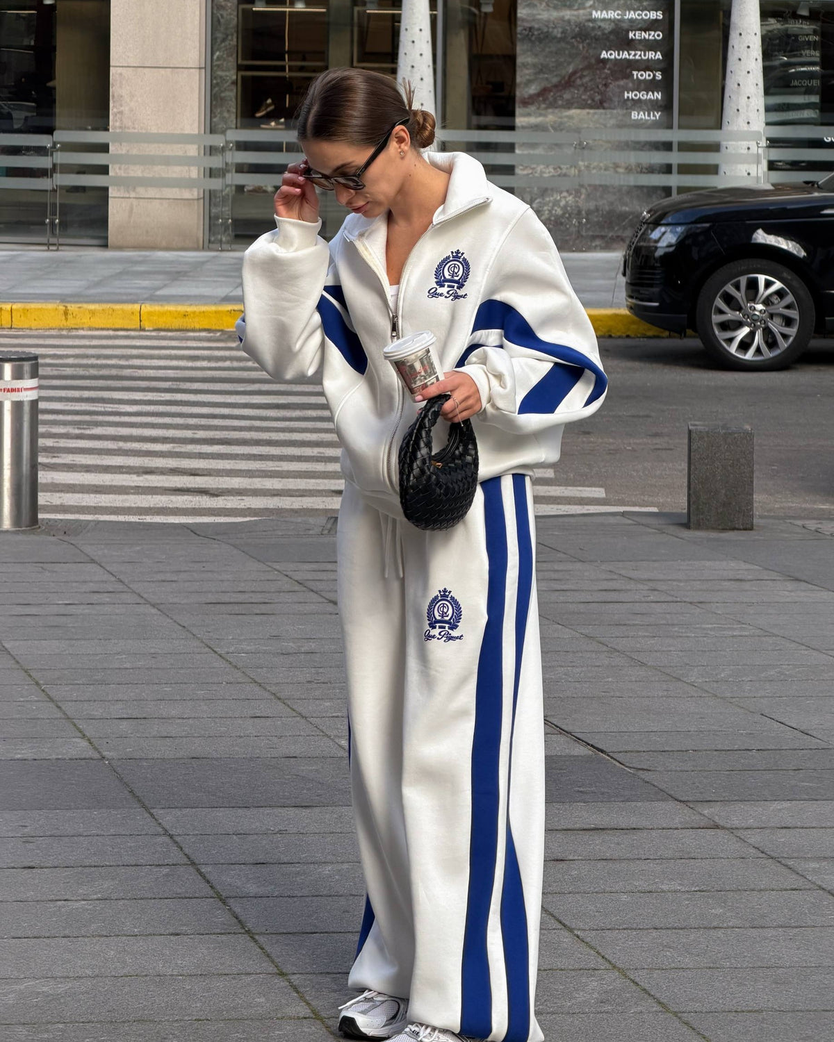 Milk-white tracksuit with blue colour-block panels and stripes - full-length view of the zip jacket and wide-leg trousers