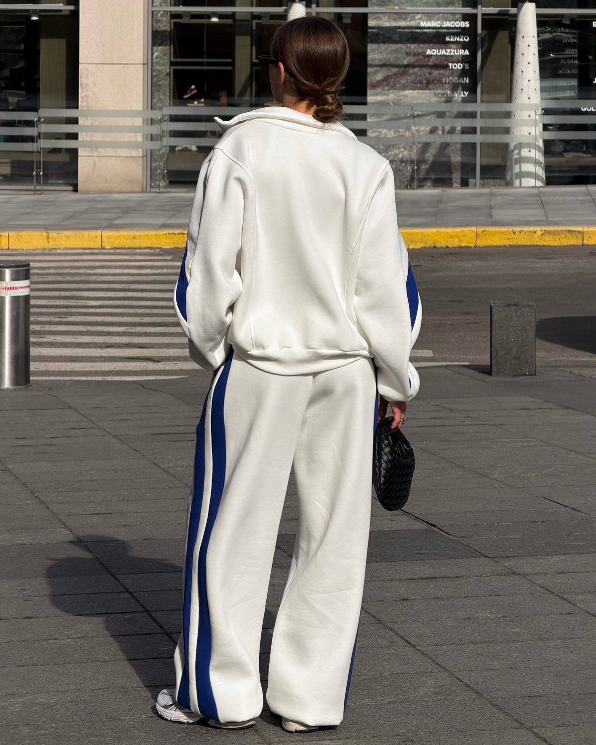 Milk-white tracksuit with blue side stripes - back view of the jacket and wide-leg trousers