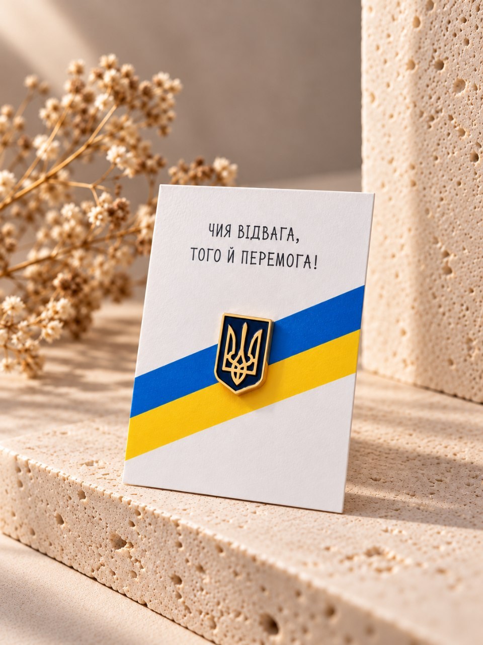Ukrainian Tryzub enamel pin on a card with the slogan Whose courage, his is the victory