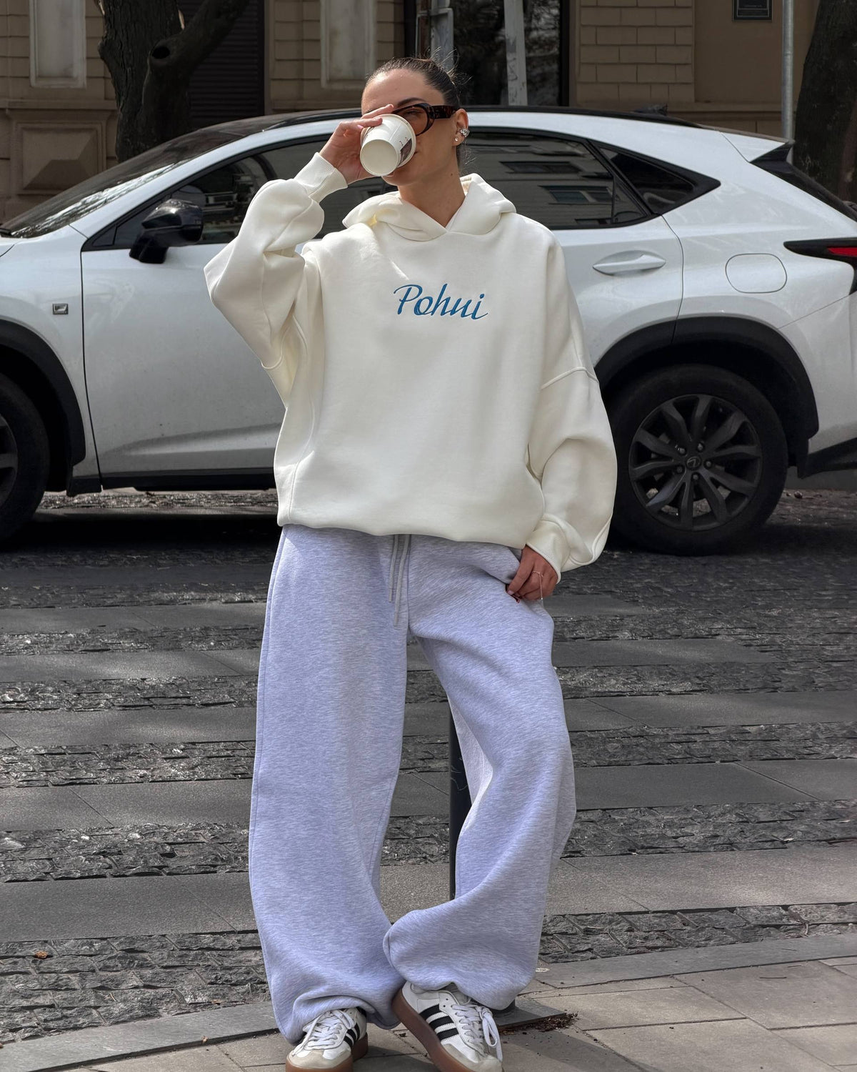 Milk-white hoodie with blue embroidery and light grey wide-leg trousers - full-length view