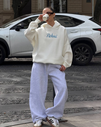 Milk-white hoodie with blue embroidery and light grey wide-leg trousers - full-length view