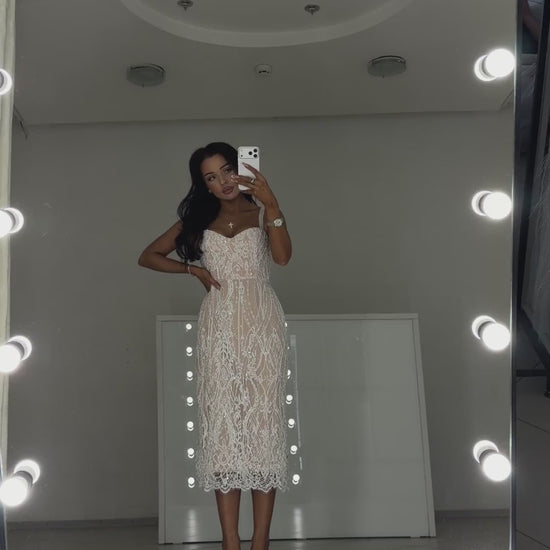Video of white pearl Chantilly lace midi dress Arabella - model shows the dress in motion and lace details