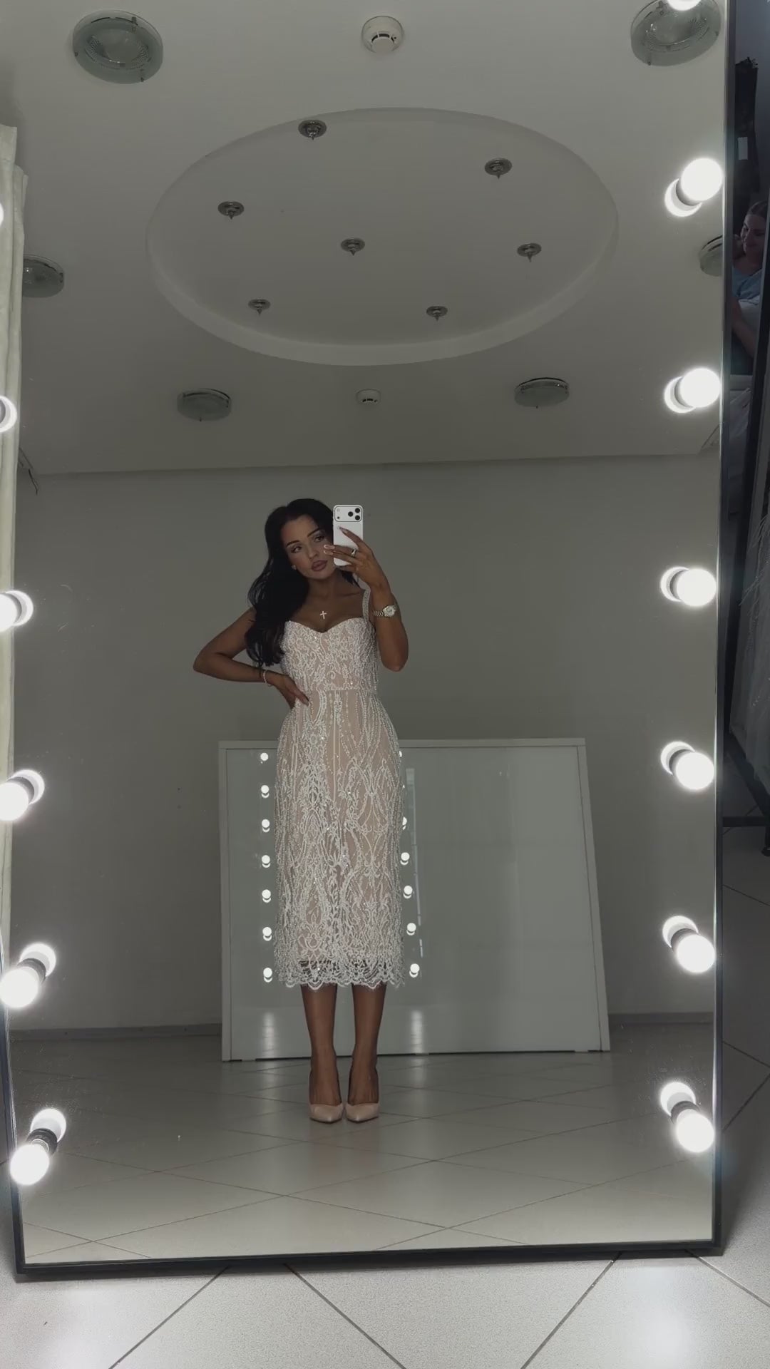 Video of white pearl Chantilly lace midi dress Arabella - model shows the dress in motion and lace details