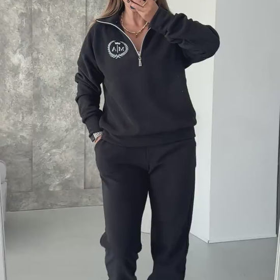 Black fleece tracksuit with half-zip sweatshirt and joggers, video