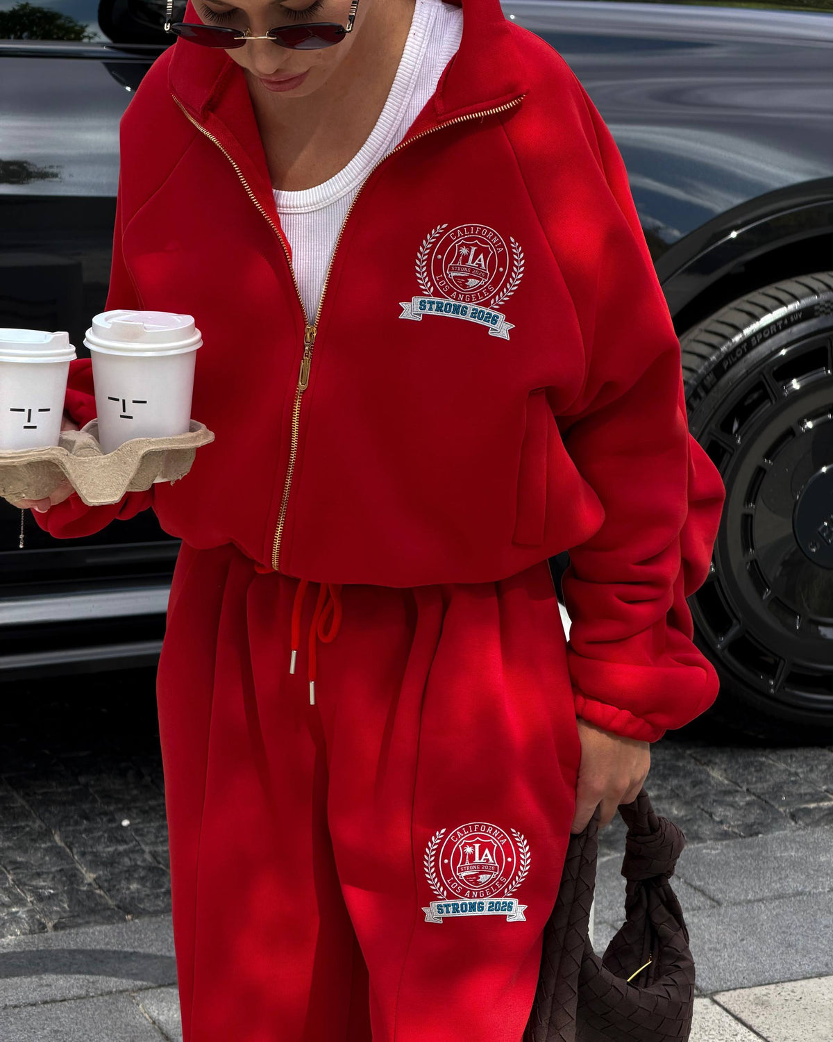 Red zip jacket and drawstring trousers with crest print - front close-up